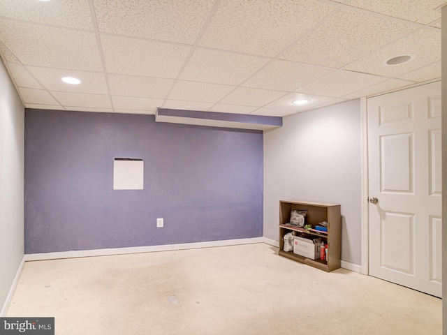 basement with a paneled ceiling