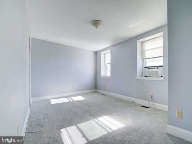 spare room with light carpet and cooling unit