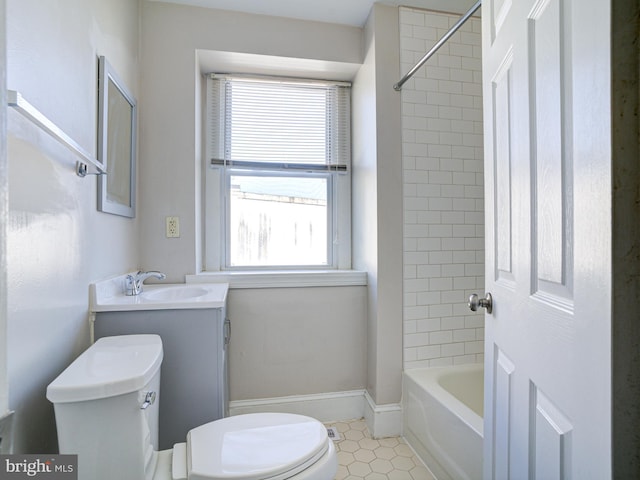 full bathroom with toilet, tiled shower / bath, vanity, and tile patterned flooring