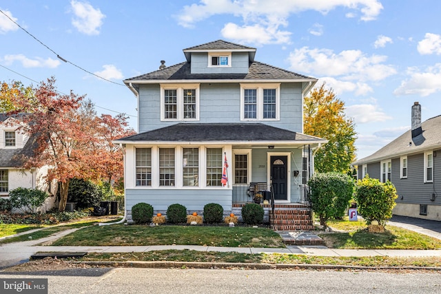 front of property with covered porch and a front lawn