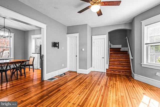 interior space with hardwood / wood-style flooring and ceiling fan with notable chandelier