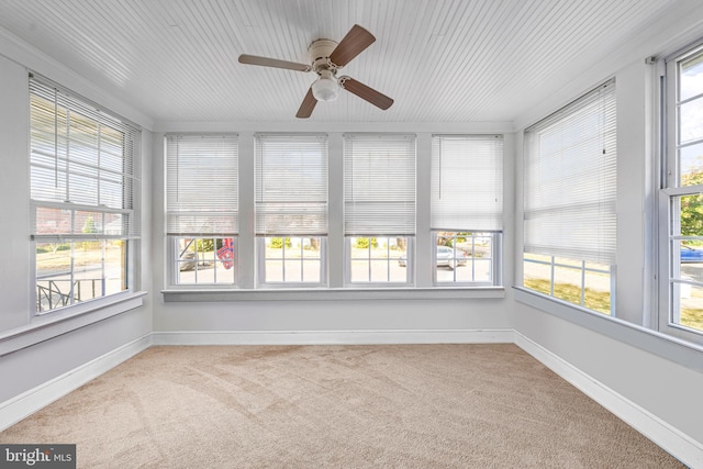 unfurnished sunroom with ceiling fan