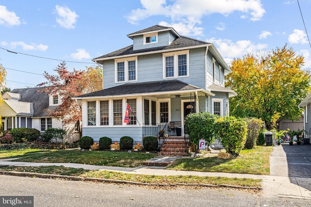 view of front property with a front yard and a porch