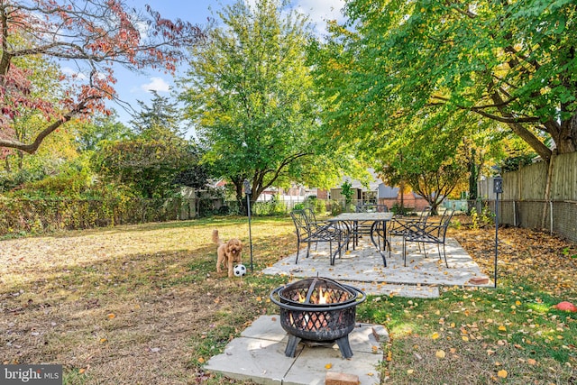 view of yard featuring a patio and a fire pit