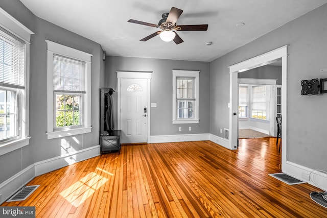 entrance foyer with ceiling fan and wood-type flooring