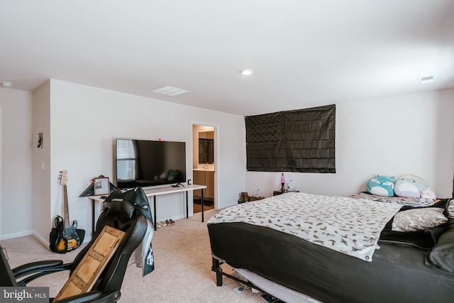 carpeted bedroom featuring ensuite bath