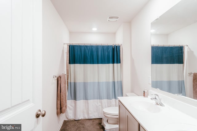 bathroom featuring vanity, toilet, and a shower with curtain