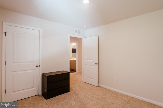 unfurnished bedroom with light colored carpet