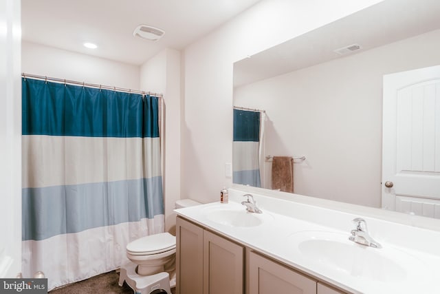 bathroom featuring vanity, toilet, and walk in shower