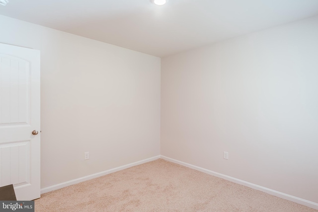 spare room featuring light colored carpet