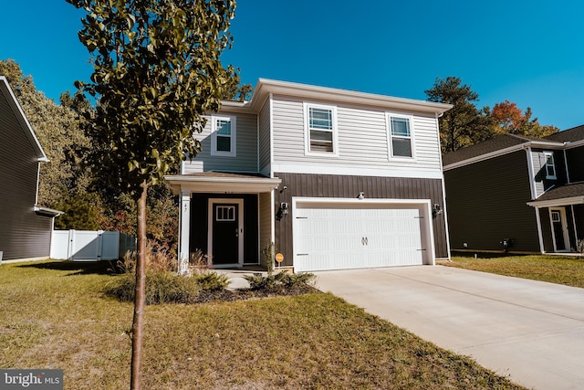 view of front of property featuring a front yard and a garage