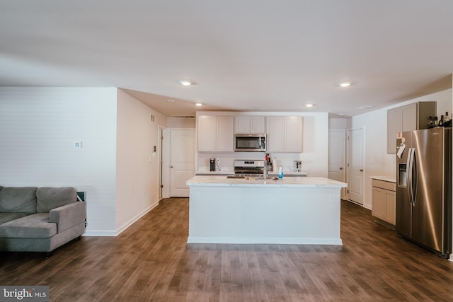 kitchen featuring a center island with sink, sink, stainless steel appliances, and dark hardwood / wood-style floors