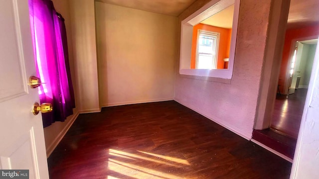 unfurnished room featuring dark wood-type flooring