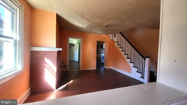 entrance foyer featuring dark hardwood / wood-style flooring and plenty of natural light