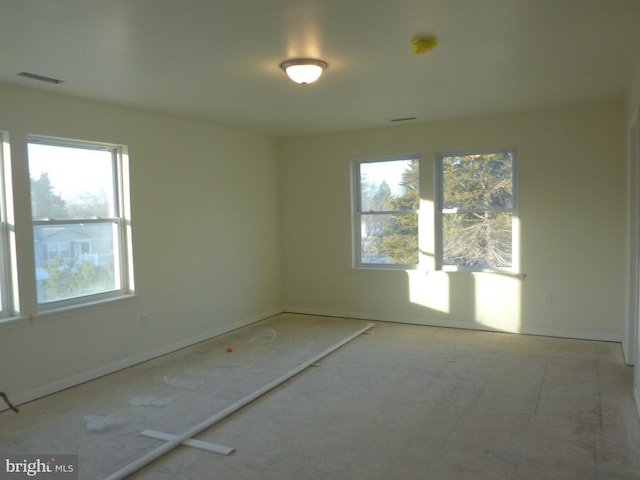 unfurnished room with visible vents and baseboards