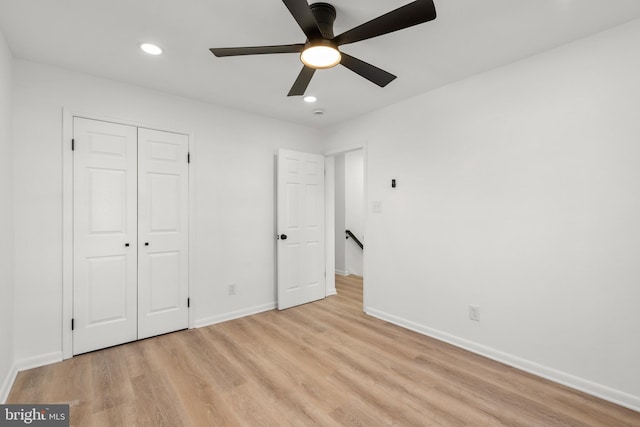 unfurnished bedroom with recessed lighting, a ceiling fan, baseboards, a closet, and light wood-type flooring