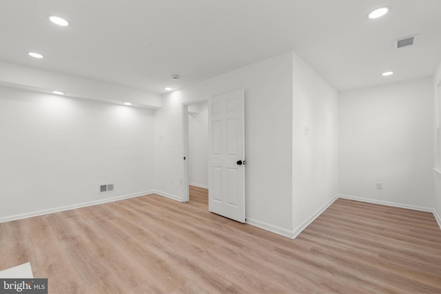 basement featuring recessed lighting, visible vents, and light wood finished floors