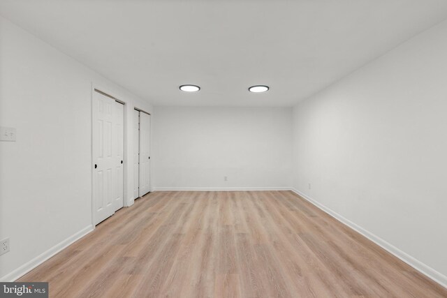 interior space featuring light wood-style flooring and baseboards