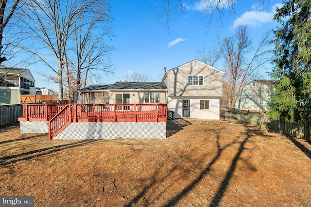 back of property featuring a fenced backyard and a deck