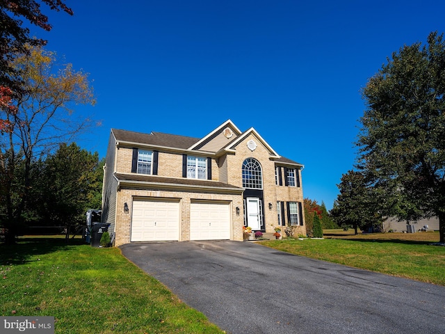 view of front of home with a front yard and a garage