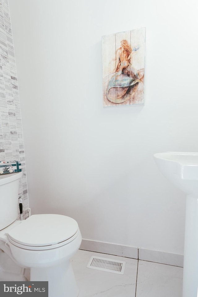 bathroom featuring tile patterned floors and toilet