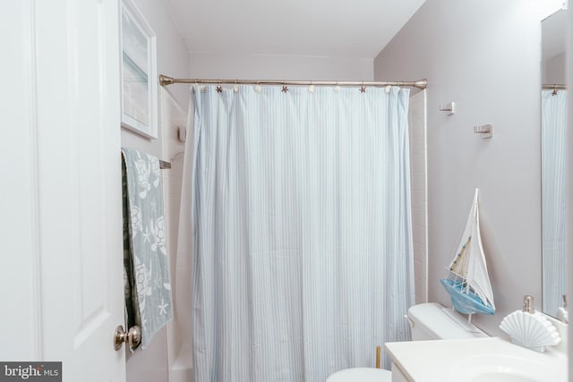 full bathroom with vanity, shower / tub combo, and toilet