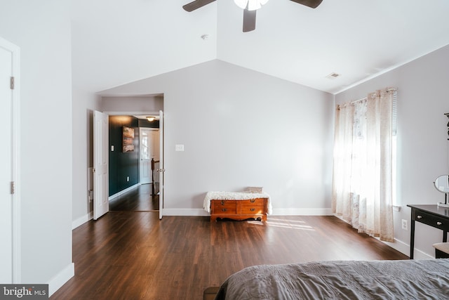 bedroom with lofted ceiling, dark hardwood / wood-style floors, and ceiling fan