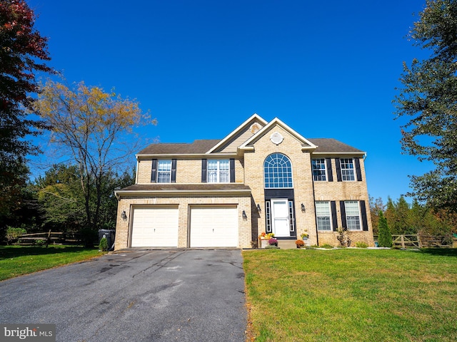 view of front of property with a garage and a front lawn