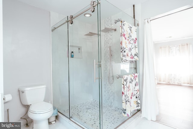 bathroom featuring toilet, curtained shower, and tile patterned flooring