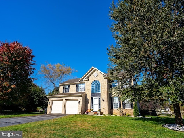 front facade featuring a front yard and a garage