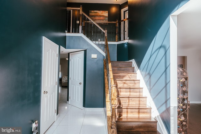 stairway with tile patterned floors