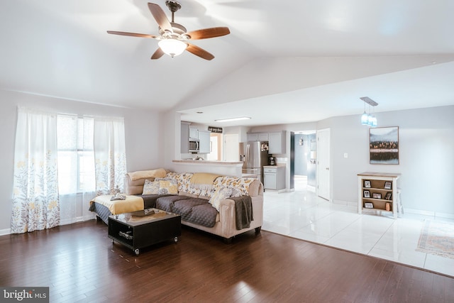 living room with lofted ceiling, wood-type flooring, and ceiling fan