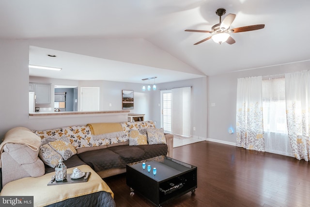 living room with dark wood-type flooring, vaulted ceiling, and ceiling fan