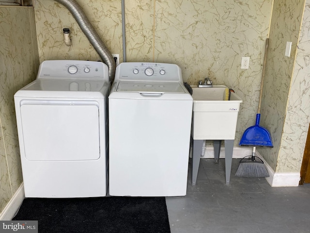 laundry room with independent washer and dryer and sink