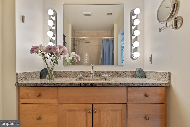 bathroom featuring vanity and a shower with shower curtain