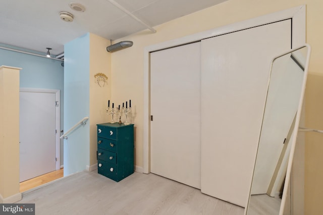 bedroom with a closet and hardwood / wood-style floors