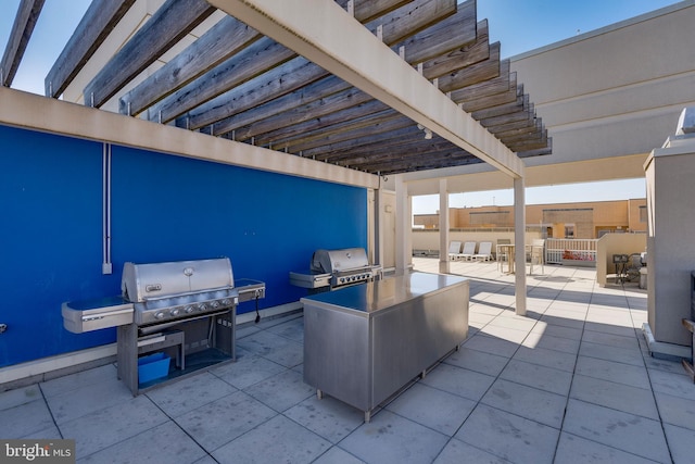 view of patio / terrace with grilling area and a pergola