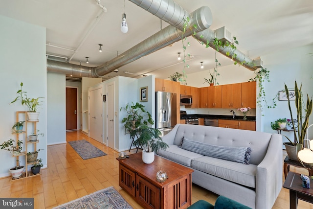 living room with sink and light hardwood / wood-style flooring