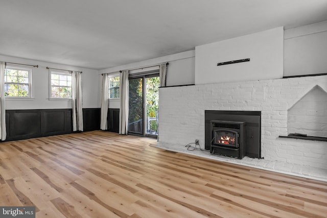 unfurnished living room featuring light hardwood / wood-style floors and a wealth of natural light