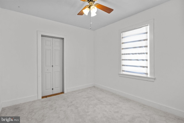 carpeted empty room with ceiling fan