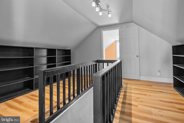 interior space featuring lofted ceiling and wood-type flooring