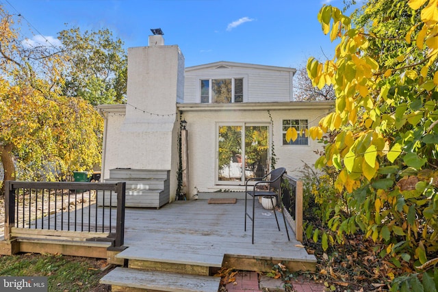 rear view of property with a wooden deck