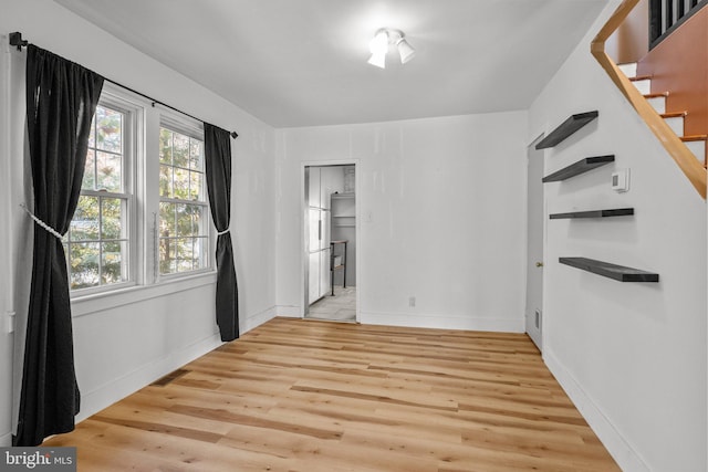 empty room with light hardwood / wood-style floors