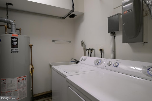 washroom with water heater, sink, and washing machine and clothes dryer