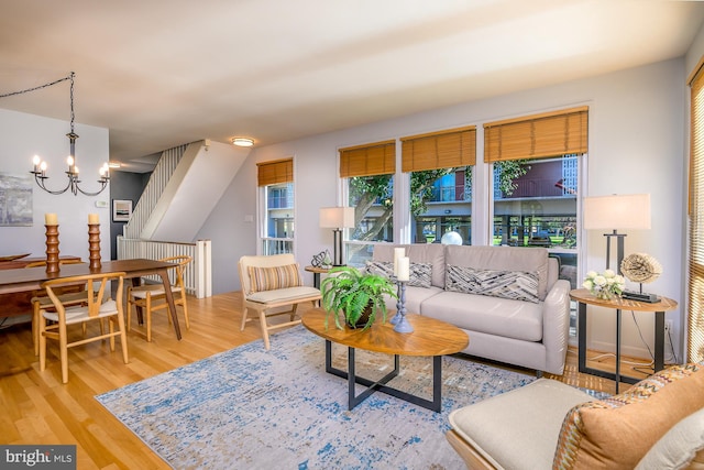 living room featuring wood-type flooring and a notable chandelier