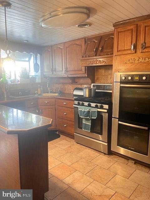 kitchen with custom exhaust hood, wood ceiling, stainless steel appliances, and sink