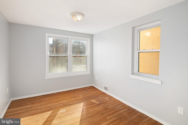 unfurnished room featuring hardwood / wood-style floors