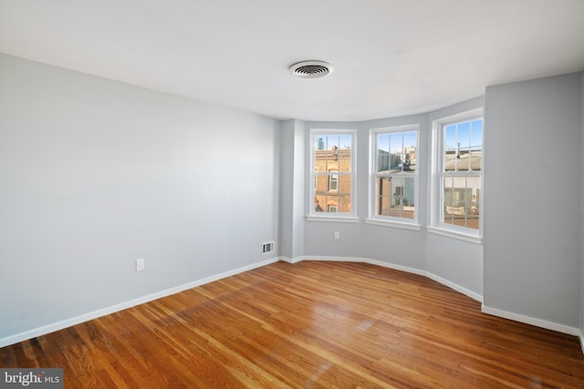 unfurnished room featuring hardwood / wood-style flooring