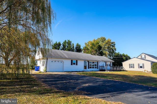 ranch-style house with a garage and a front yard