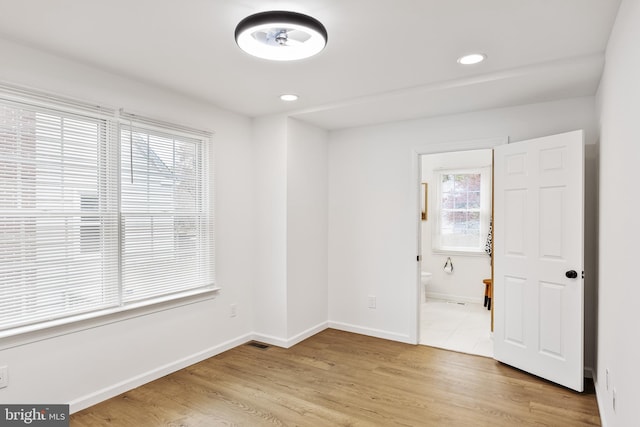 empty room with light hardwood / wood-style flooring